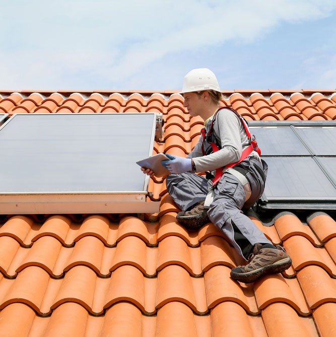 Man-on-roof-top-checking-on-solar-panel-installation